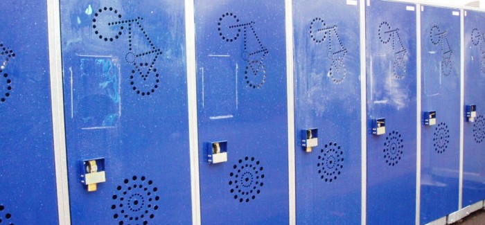 A row of blue vertical bike lockers