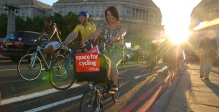 Cyclists on Lambeth bridge with Space for Cycling sign