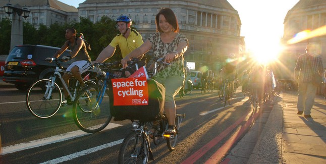 Cyclists on Lambeth bridge with Space for Cycling sign