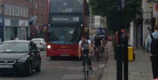 Cyclists squeezing past a bus at Camberwell Green